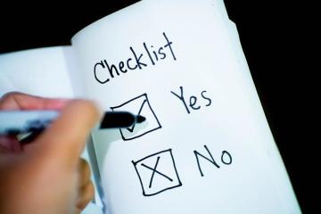 Individual checking off items on a checklist