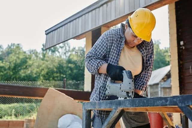 Photo by Mikael Blomkvist: https://www.pexels.com/photo/woman-in-blue-and-white-plaid-shirt-wearing-yellow-hard-hat-8961395/