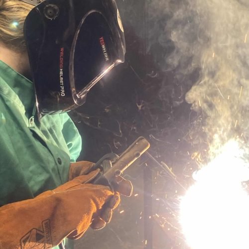 Step Up student practicing welding skills they learned during class.