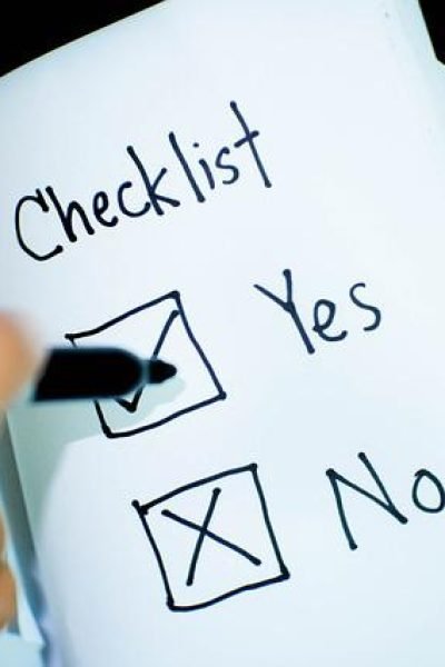 Individual checking off items on a checklist